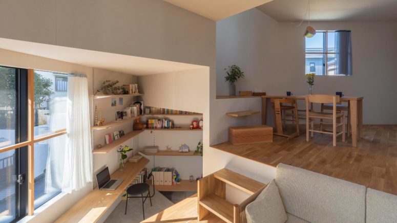 bookcases used to divide space are quite practical The levels aren't separated with walls or partitions but are divided with bookcases and other furniture pieces