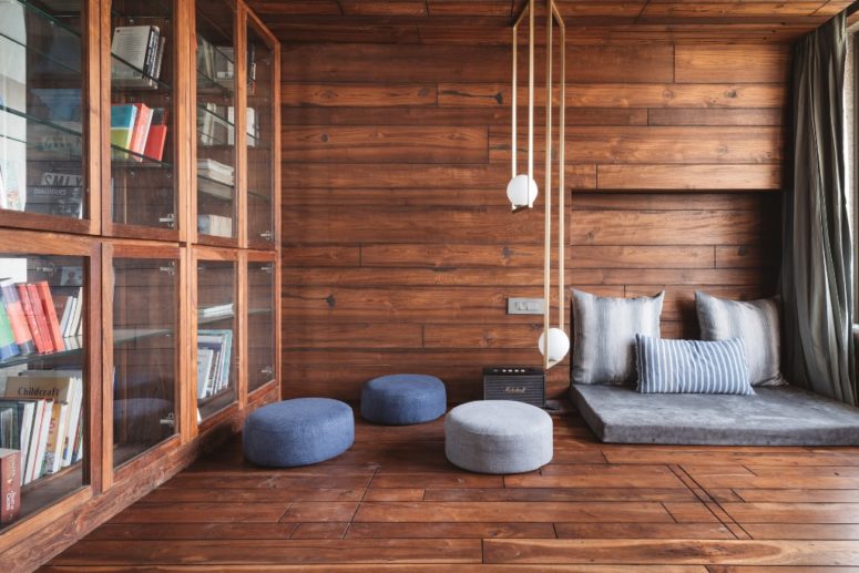 This stylish and cozy reading nook is clad with rich stained wood, contemproary furniture and lots of bookcases This stylish and cozy reading nook is clad with rich stained wood, contemproary furniture and lots of bookcases