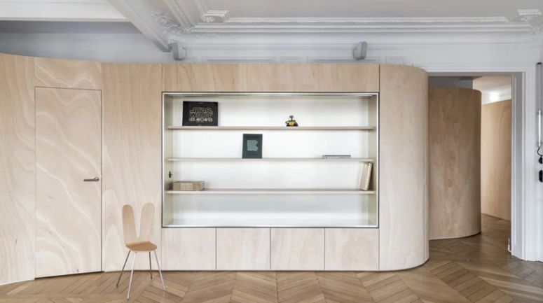 This wooden wall features some storage space, too, and it wraps the whole apartment dividing it into zones and keeping the historical touches seen This wooden wall features some storage space, too, and it wraps the whole apartment dividing it into zones and keeping the historical touches seen