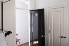 02 a glossy black door adds interest and chic to the neutral spaces and gives them a trendy feel