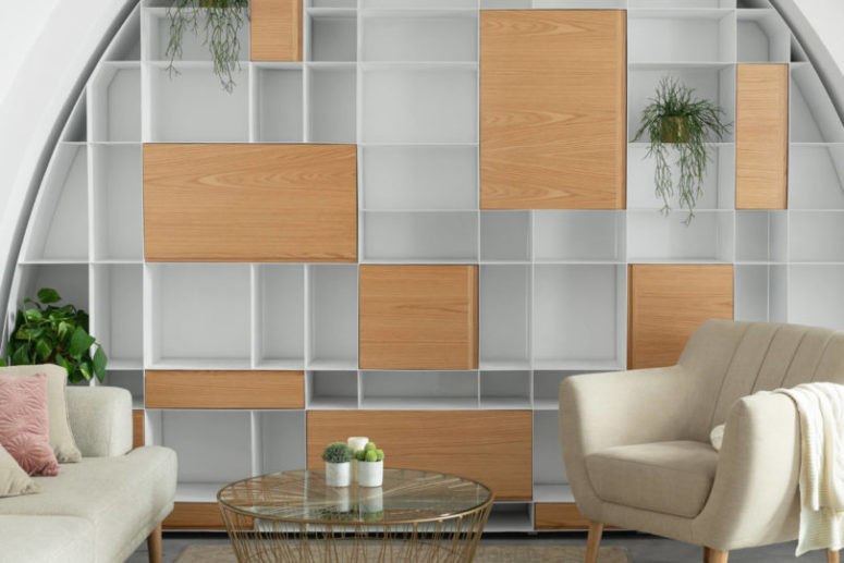 The shelving unit is catchy yet simple and features both open and closed storage