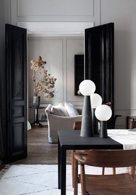 glossy black doors match the refined spaces and add more chic to them echoing with some black objects here