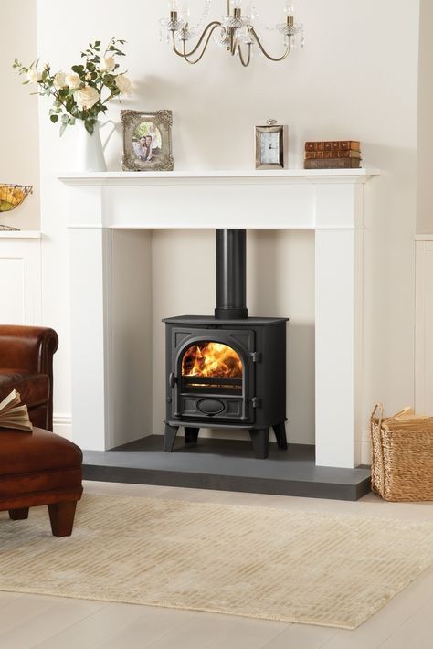 highlight your wood burning stove placing it into a niche with a concrete floor