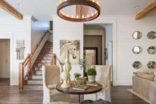 04 This cute sitting zone shows off two vintage chairs and is highlighted with a bold rustic chandelier, which is modern