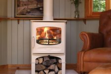 04 a white wood burning stove is an elegant idea, firewood under it is a cool idea to store it