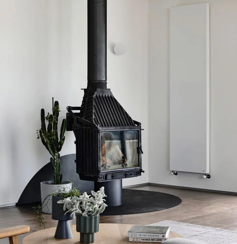 a vintage stove is perfect addition to make any space cozy There's a large vintage hearth in black that makes a statement in the space and potted greenery and succulents