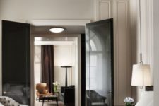 05 refined neutral interiors spruced up with dark touches – rich browns and black, glossy black doors are a bold statement