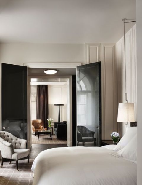 refined neutral interiors spruced up with dark touches - rich browns and black, glossy black doors are a bold statement