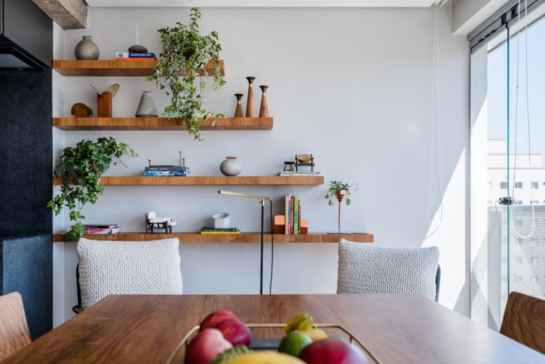 Open shelving paired with crochet covered chairs make the dwelling feel relaxed and boho-like