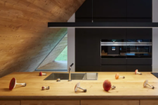 a cozy kitchen with black cabinets