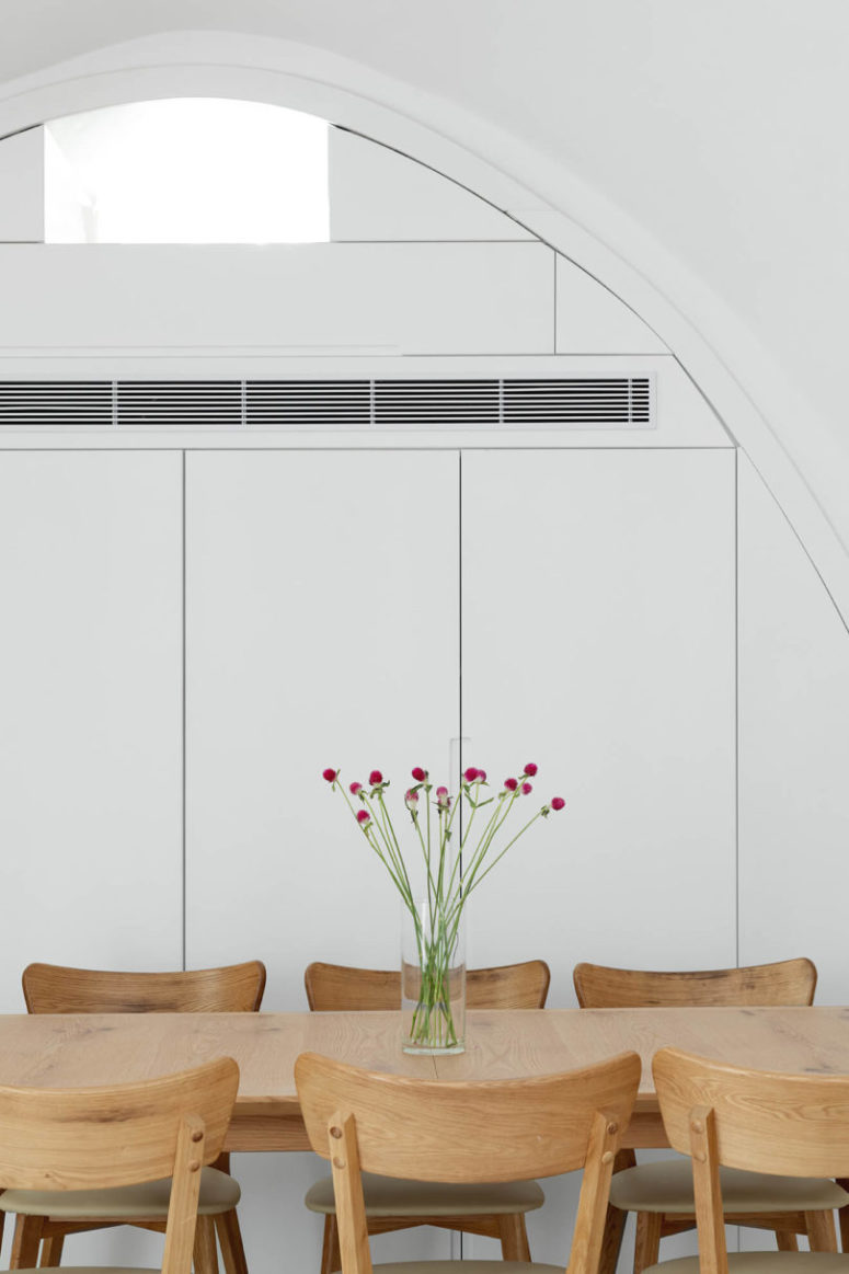 There's a large storage unit covered with sleek white doors