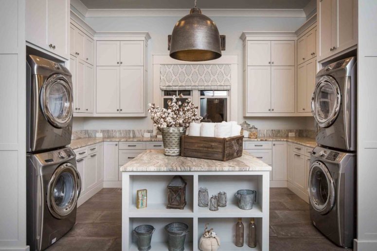 The laundry room features several washing machines, neutral furniture and a large island