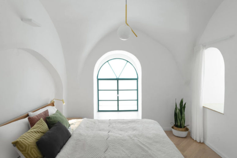 The bedroom is done in white and spruced up with a bit of color - green, mustard, burgundy