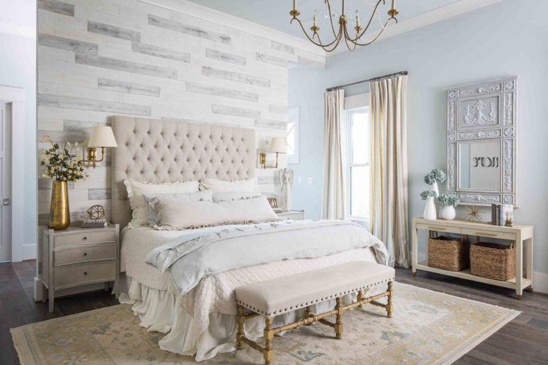 The bedroom is elegant and refined, with an accent wall, chic furniture and an ornate mirror