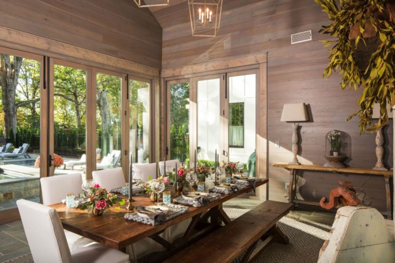 The dining room is clad with dark wood, stained dining set and glazed walls