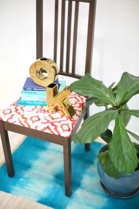 a simple IKEA kitchen chair reupholstered with bright printed fabric to make it bolder and more catchy