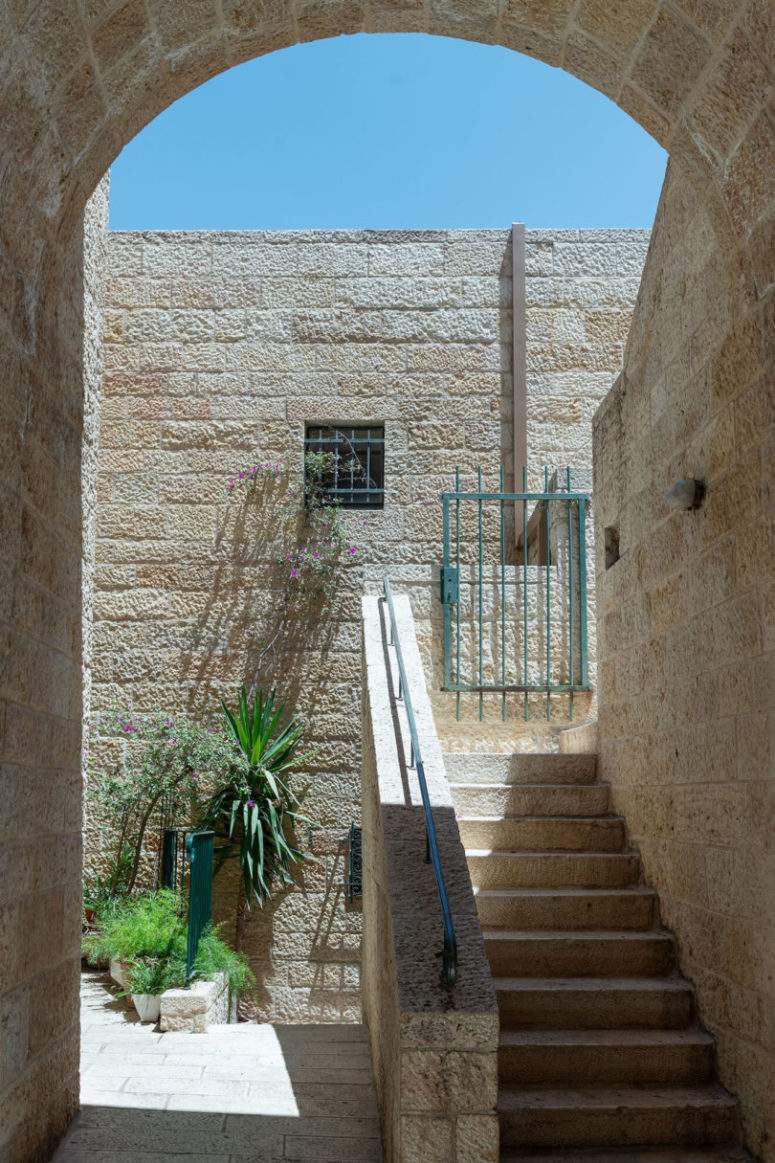 There's also an open backyard of stone enlivened with some potted greenery