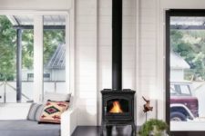 13 a black wood burning stove with firewood storage underneath in a contemporary and stylish living room