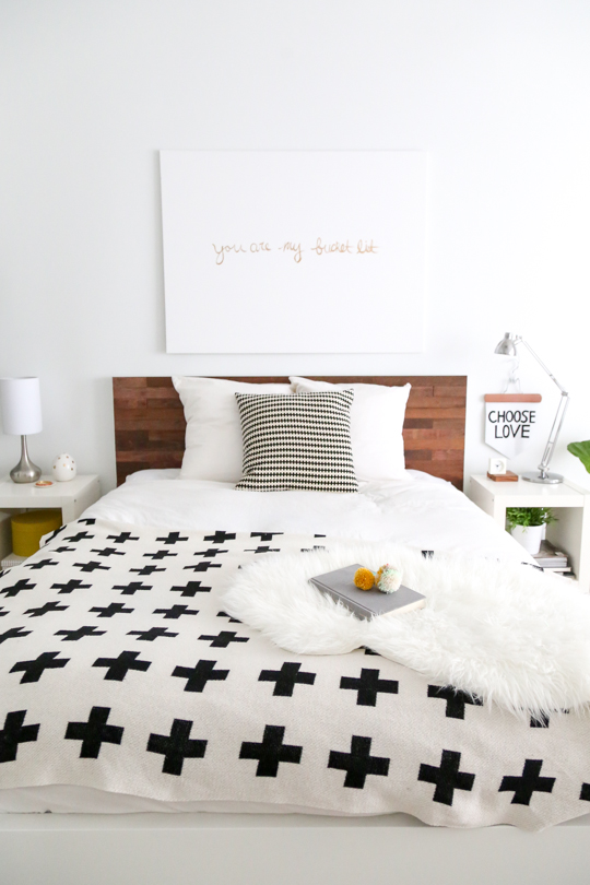 an IKEA Malm bedframe is renovated using some stikwood and screws to make it look stylish and natural