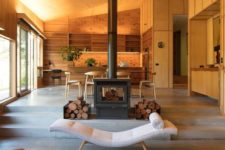 21 a stylish wood burning stove with some firewood can work as a cool space divider that cozies up the spaces