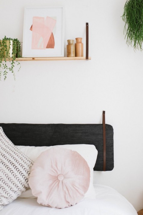 turn a bench cushion from IKEA into a black denim covered headboard for comfortable leaning here