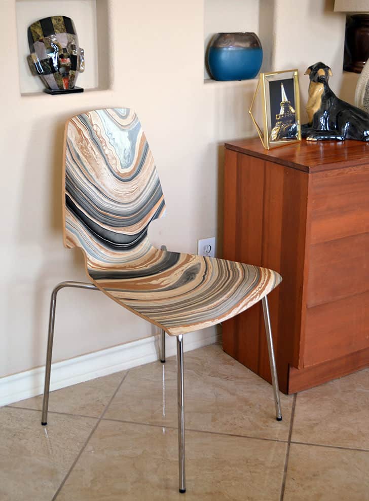 an IKEA Vilmar chair marbled using Mod Podge, paints and brushes looks super catchy, bold and outstanding