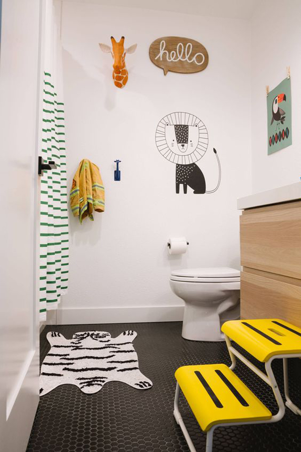 a bright yellow step, fun wall decor with a fake giraffe head and a whimsical animal rug