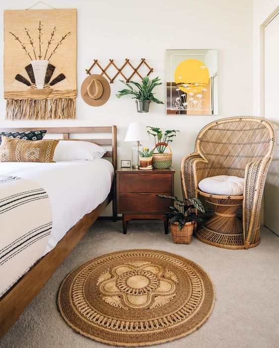 a jute rug and artwork with jute, a wicker chair ad some boho printed pillows for a relaxed boho space