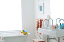a neutral bathroom made fun and cheerful with colorful kids’ accessories and furniture in all kinds of shades
