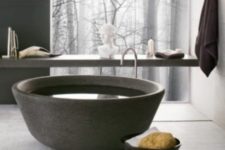a unique bowl-like stone bathtub is an ultimate solution for a contemporary or minimalist bathroom