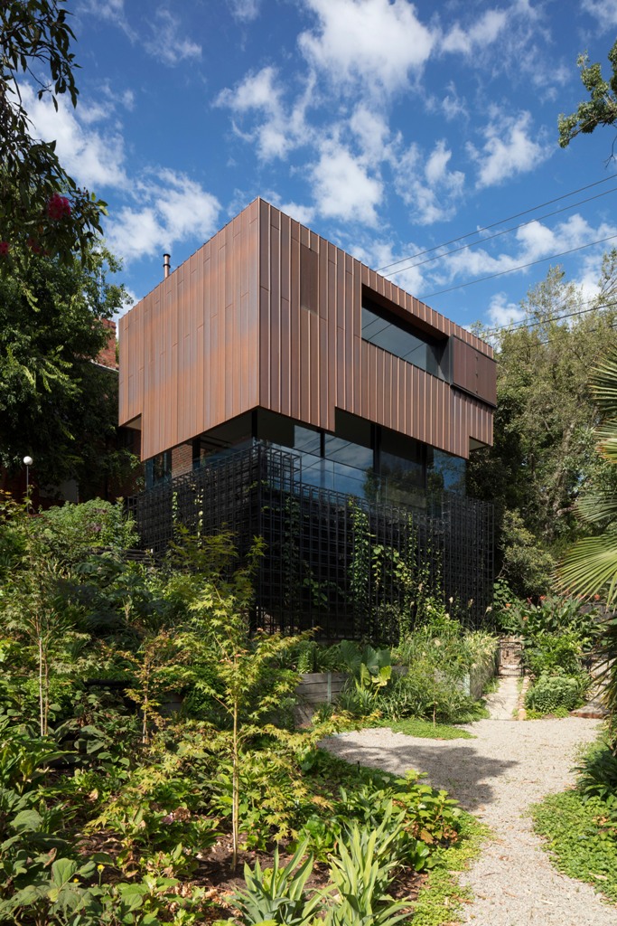 The house is clad with copper panels that will patina over time and will look like furniture inside the house