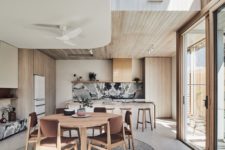 02 The kitchen is done with a black marble backsplash and matching countertops, the dining space features comfy chairs