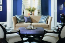 02 a small living room done in blueberry blue, with a black and white tile floor, various prints and arched windows