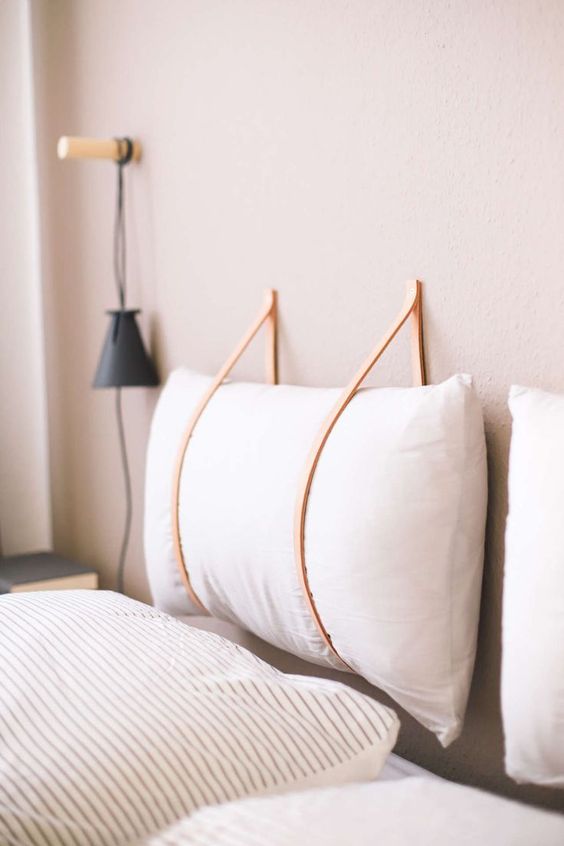 https://www.digsdigs.com/photos/2020/03/02-make-a-hanging-headboard-yourself-hanging-soem-soft-pillows-on-leather-cords-to-secure-them-right.jpg