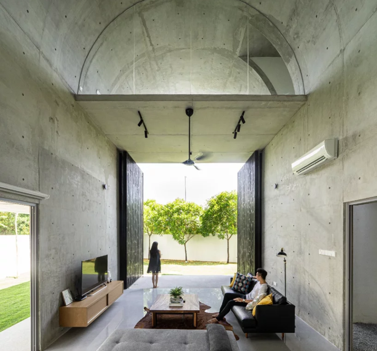 The contemporary design is continued indoors, too, with simple furniture and all concrete everything