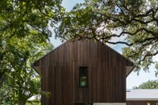 03 The exterior of the house is clad with weathered wood and has a natural finish