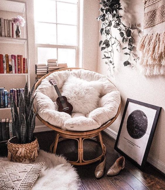 a cool music playing nook with a papasan chair of rattan, with a white futon and a faux fur pillow is amazing