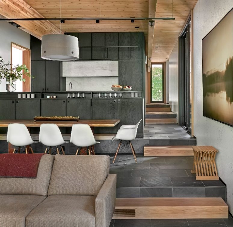The house is an open layout with a living room and dining zone and kitchen together, there's a lot of wood and plywood in decor The house is an open layout with a living room and dining zone and kitchen together, there's a lot of wood and plywood in decor