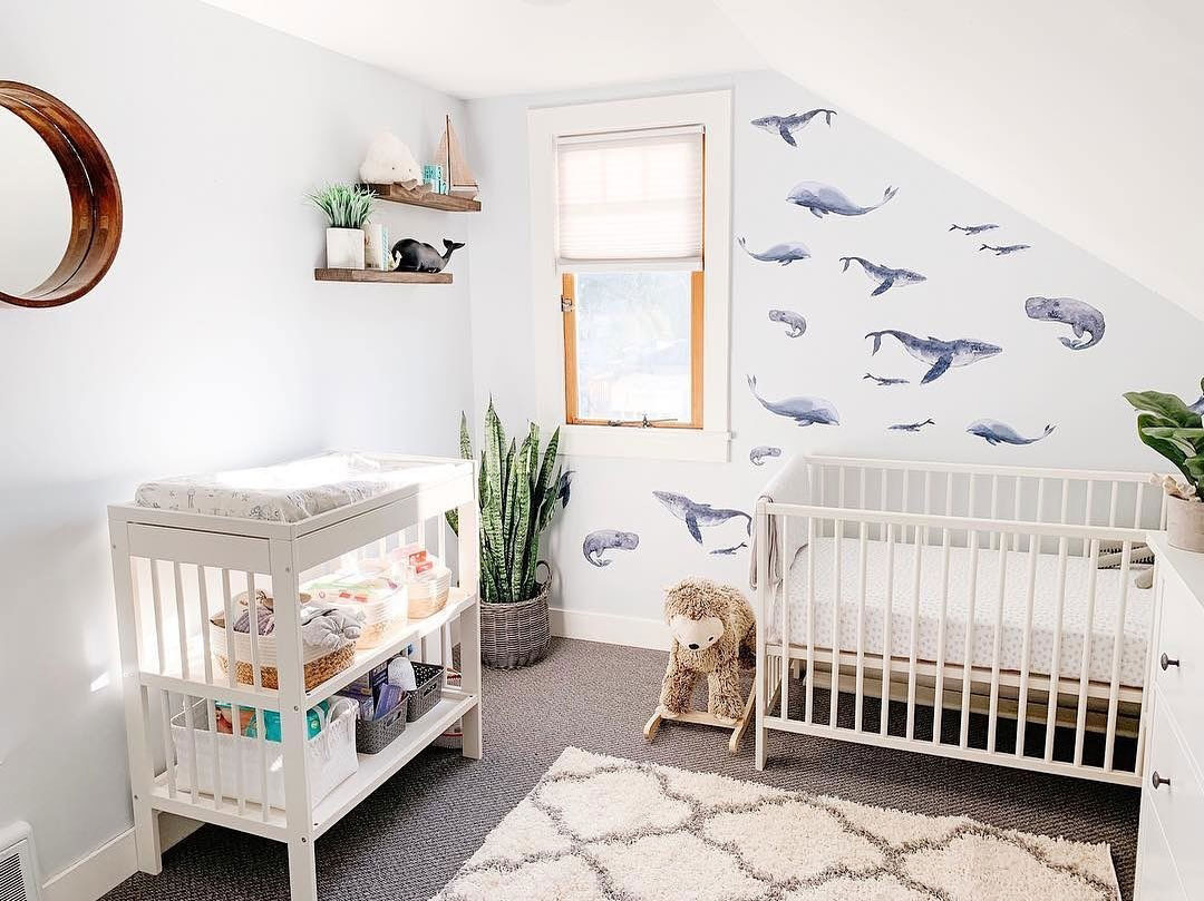 a serene bedroom with a whale print wallpaper wall for an accent is a cool and inviting space