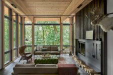 05 Another living room is done with neutral elegant furniture, a fireplace and full glazing to enjoy the views