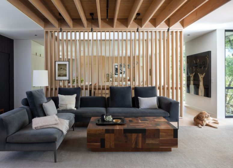The interior is brighter and more colorful by comparison, featuring white walls and large windows plus much wood