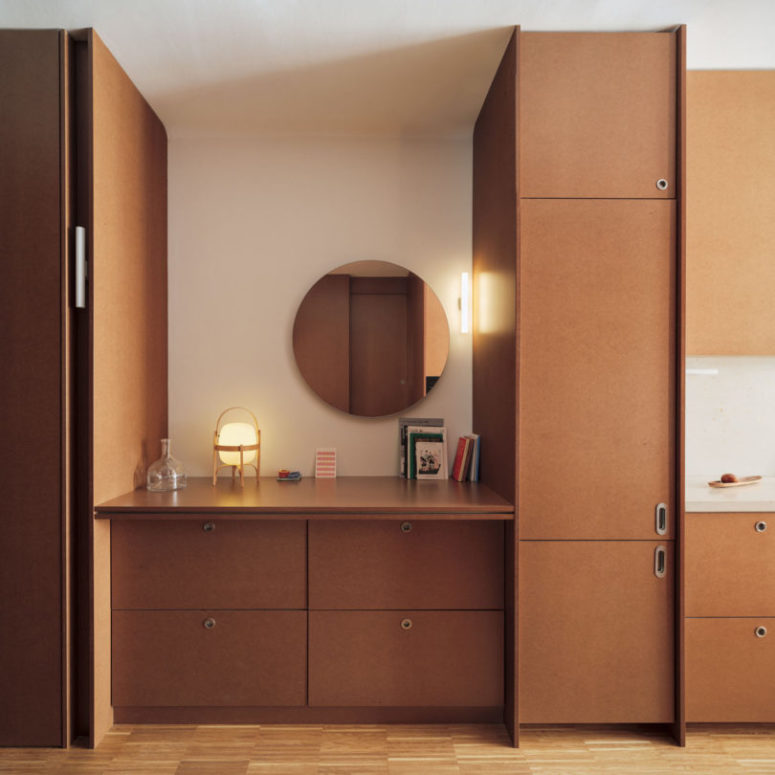 The entryway is done with cabinets of the same shade as the kitchen to make the space continuous and harmonious