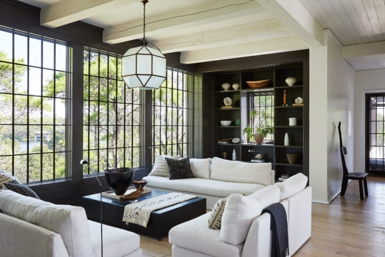 living room with cool built ins The living room is done in black and white, with geometric lamps, a glazed wall and built-in shelves