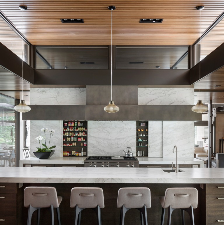The long kitchen island doubles as an eating space