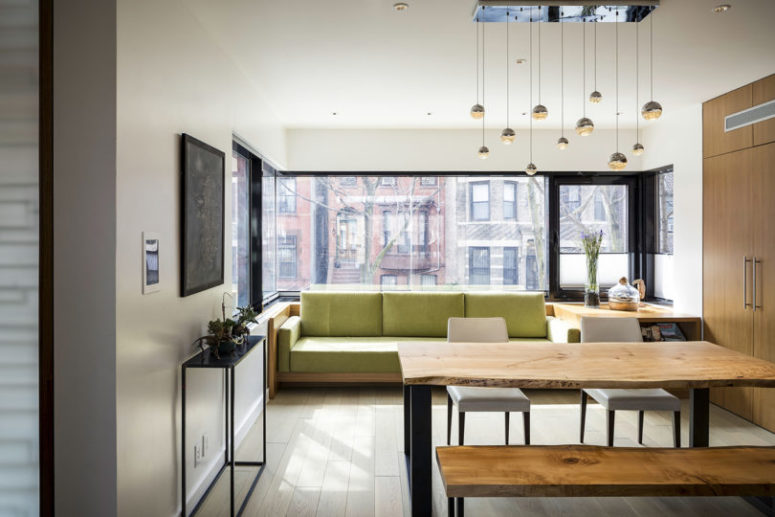 There's a green sofa and another tiny table in the kitchen to have meals here