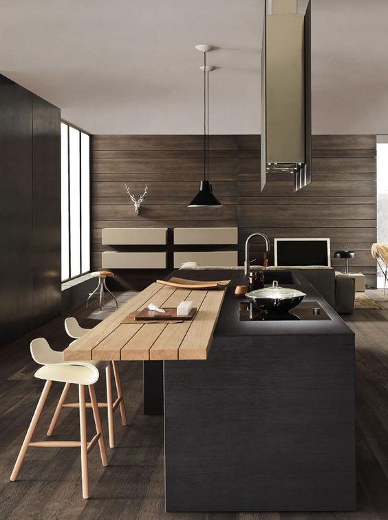 a dark minimalist kitchen with a statement kitchen island and an additional countertop for eating here