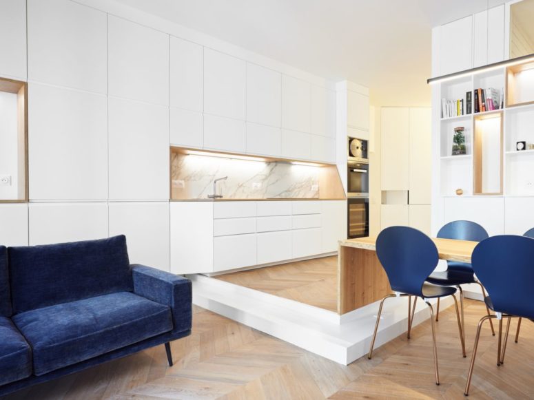 The open kitchen is slightly raised and that adds a clear border around it, I love the white marble backsplash, it's pure luxury