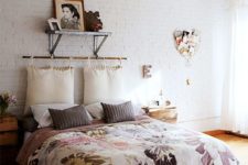07 a bright and cheerful bedroom with floral bedding and hanging pillows for a headboard looks romantic and soft