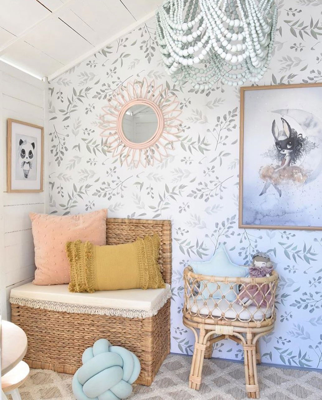 a sweet farmhouse nursery with a delicate leaf print wall that makes the space softer and more welcoming