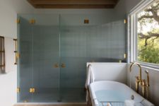 a walk in shower surrounded by textured glass